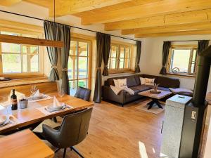 a living room with a table and a couch at Ferienhaus Bergmann in Bad Aussee