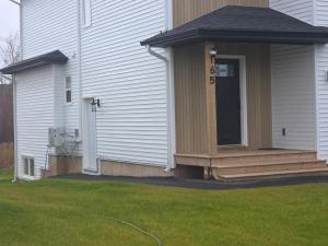 a front porch of a house with a door at Cozy Haven Suite in Moncton