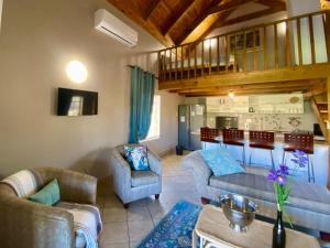 a living room with a couch and chairs and a table at Rondeberg Holiday Resort in Clanwilliam