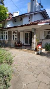 a house with a stone patio in front of it at Recanto da Ladeira in Gramado