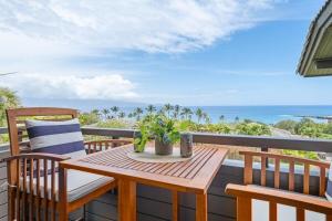 a wooden table and chairs on a balcony with the ocean at Kapalua Ridge Villas 311 · KRV 311 Beautiful Kapalua Villa for W in Kahana