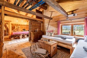 Blockhausschlafzimmer mit einem Bett und einem Schreibtisch in der Unterkunft Kaiserhaus Holiday Apartments in Ebbs