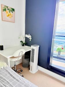 a bedroom with a bed and a desk and a window at Private Room and bathroom in Shared Apartment with Host in Box Hill