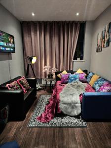 a living room with a bed and a couch at Entire 1 Bedroom Apartment in London - 5 Mins from Heathrow - Sleeps 5 in Harmondsworth