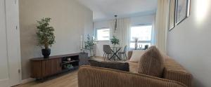 a living room with a couch and a table at Studio Magnolia Suite in Poznań