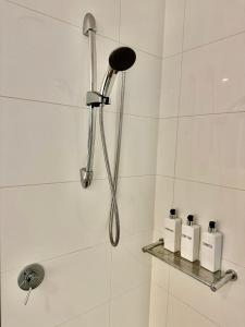 a shower with a shower head and two soap bottles at Private Room and bathroom in Shared Apartment with Host in Box Hill +12 photos