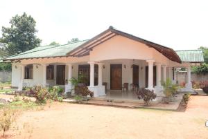 a small white house with a porch at First House Mihintale in Mihintale