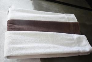 a stack of towels sitting on top of a counter at First House Mihintale in Mihintale
