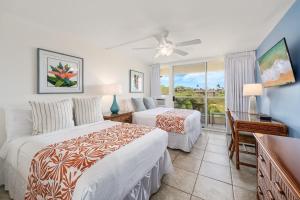 a bedroom with two beds and a balcony at Maui Banyan P301 · MB P301 Remodeled 2BD Condo Across Beach Pool in Wailea +43 photos
