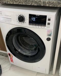 a white washing machine sitting in a kitchen at Loft vista incrível beira mar continental in Florianópolis