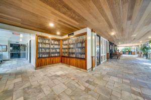 a library with wood paneling and shelves of books at Mahana 1008 · MA 1008 Luxury BeachFront Condo in Kahana