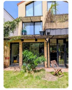 a chair sitting in front of a house at Maison entre tour Eiffel et château de Versailles in Sèvres