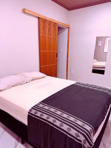 a bedroom with a large bed with white sheets at Ares da Bocaina Suítes in Bananal +19 photos