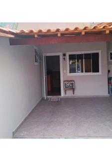 a white house with a door and a window at Ares da Bocaina Suítes in Bananal