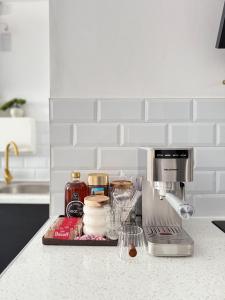 a kitchen counter with a coffee maker and ingredients at New Modern 2 Bedroom Central Apt Greater Manchester, Sleeps 5, Near Airport with Great Transport Links in Stockport