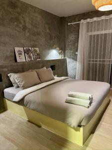a bedroom with a large bed with towels on it at The Summer Cottage Koh Chang in Khlaung Phai Bae