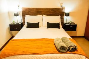 una camera da letto con un letto grande con asciugamani sopra di Casa tipo Estudio de concepto abierto, Centrica, Parrilla, Cochera Privada y Portón Eléctrico a San Nicolás de los Arroyos