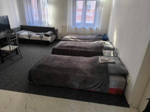 a room with two beds and a couch at Apartmán Hanka in Pardubice