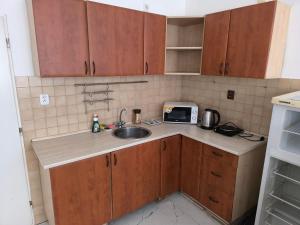 a small kitchen with a sink and a microwave at Apartmán Hanka in Pardubice