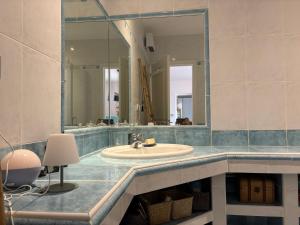 a bathroom with a sink and a large mirror at vue sur le golfe de Saint Florent in Saint-Florent +20 photos