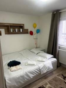 a bed with two towels and a balloon on it at DAVID Resident in Cavnic