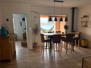 a kitchen and dining room with a table and chairs at vue sur le golfe de Saint Florent in Saint-Florent