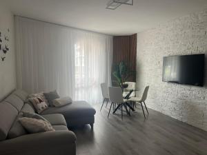 a living room with a couch and a table at Garden Lake Apartment in Peschiera del Garda