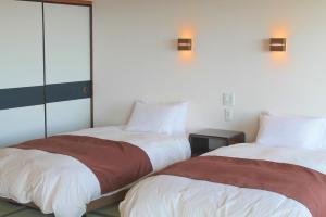 Postel nebo postele na pokoji v ubytování Ashizuri Kokusai Hotel + 48 fotografií