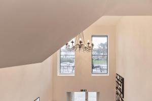 a dining room with a chandelier and windows at 2-Bed Apartments a Short Walk to Wembley Stadium in London +161 photos