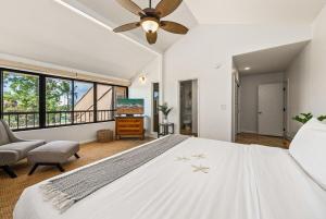 a bedroom with a large white bed and a flat screen tv at Kaanapali Royal A303 · KRL A303 Relaxing Hawaiian 2BD on Golf Co in Lahaina +63 photos
