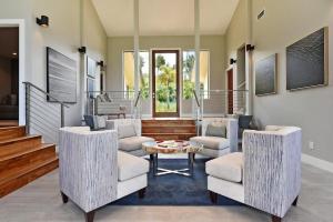 a living room with two chairs and a table at Hale Nui · HALE NUI Luxury Retreat 5BD w Private Pool Hot Tub in Kaanapali