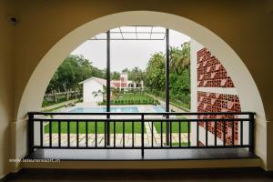a view from the balcony of a house with a pool at Leisure Resort in Pondicherry