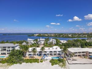 an aerial view of a resort on the beach at Ground Floor Oceanview Open Tonight Morning Arrival Possible! in Longboat Key