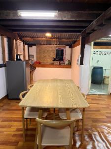 a table and chairs in a room with a kitchen at Balance home happy in Ko Yao Noi +8 photos