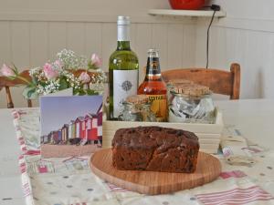 a chocolate cake on a table with a bottle of wine at The Broomes in Whitstable