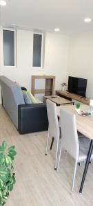 un salon avec un canapé, une table et des chaises dans l'établissement Beautiful View - Arco da Calheta - Ilha da Madeira, à Arco da Calheta