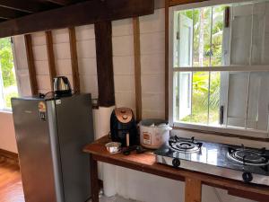 a kitchen with a stove and a refrigerator and a window at Balance home happy in Ko Yao Noi