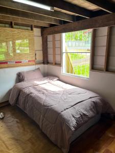 a bed in a room with a window at Balance home happy in Ko Yao Noi