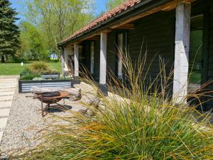 a porch of a house with a bench and grass at The Stables - Uk50804 in Cratfield