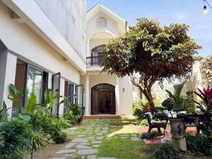 a house with a walkway leading to the front door at K'TY Homestay Phan Thiết in Ấp Bình Hưng