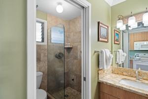 a bathroom with a shower and a toilet and a sink at Napili Bay 210 · NB 210 Napili Bay Studio with Direct Ocean View in Kahana +40 photos