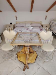 a bedroom with a bed and a table and chairs at Apartman Teo in Požarevac +37 photos