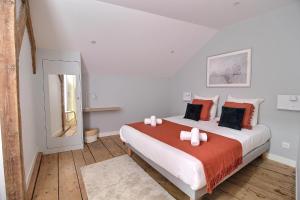 a bedroom with a large bed with red and white pillows at Le Logis Saint-Ursin by PRIMO C0NCIERGERIE in Bourges +6 photos
