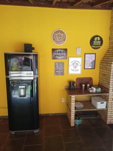 ein schwarzer Kühlschrank in einem Raum mit einer Theke in der Unterkunft Suítes em Casa linda na Serra Paty do Alferes Rj in Paty do Alferes