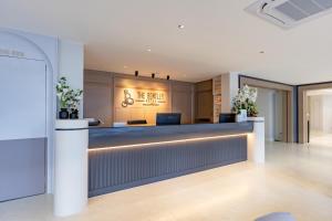 a lobby with a reception desk in a building at The Bentley Hotel in Bangkok
