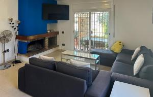 a living room with a couch and a table at 4 Bedroom Lovely Home In Creixell in Roda de Bará