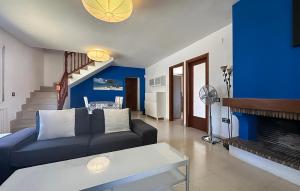 a living room with a couch and a fireplace at 4 Bedroom Lovely Home In Creixell in Roda de Bará