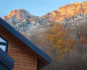 a cabin with the mountains in the background at Boga Chalet in Bogë
