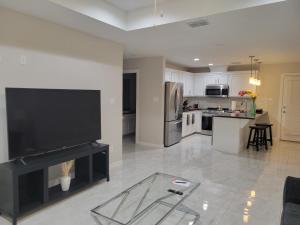 a living room with a television and a kitchen at Serene Mission Oasis! in Mission