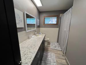 a bathroom with a sink and a toilet and a mirror at 600 Lakeshore home in Lake City +50 photos